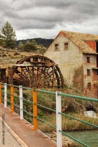 Old wooden waterwheel and Cabriel River on its way through Casas del Rio village, Albacete, Spain.