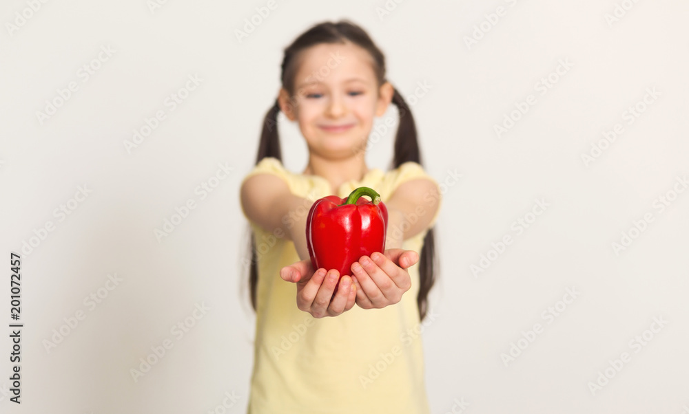 Pretty cute little girl with bell pepper over white background Pretty cute little girl with bell pepper over white background