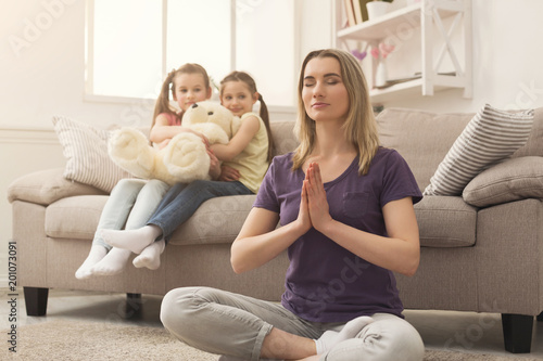 Young woman doing yoga exercise at home