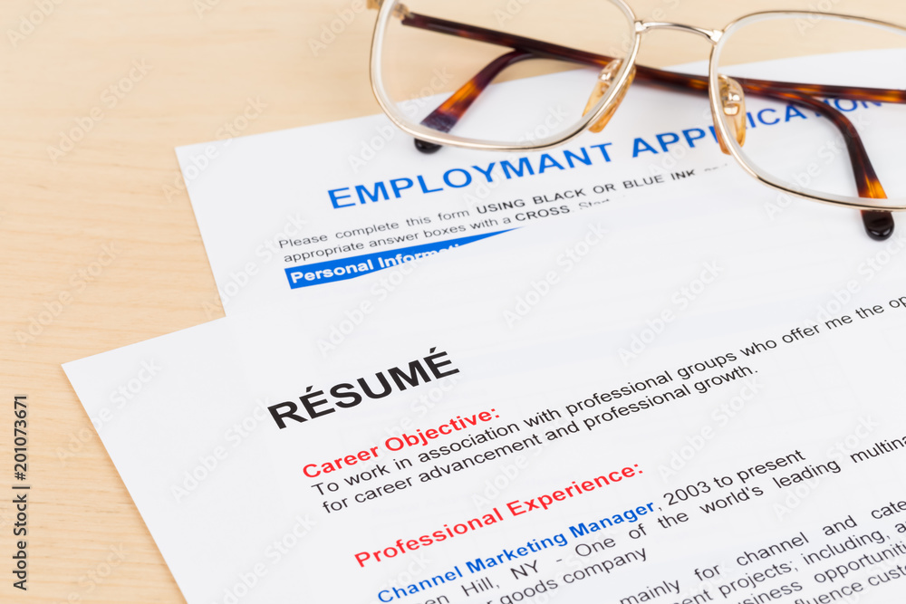 Resume and employment application form with glasses Resume and employment application form with glasses