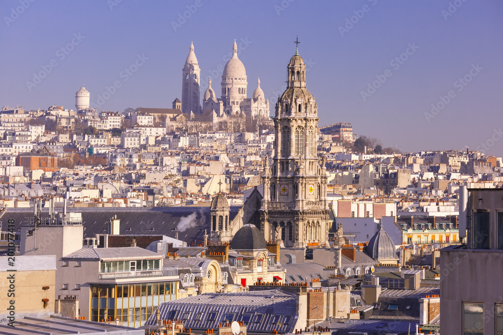 Aerial view of Sacre-Coeur Basilica or Basilica of the Sacred Heart of Jesus at the butte Montmartre and Saint Trinity church in the morning, Paris, France