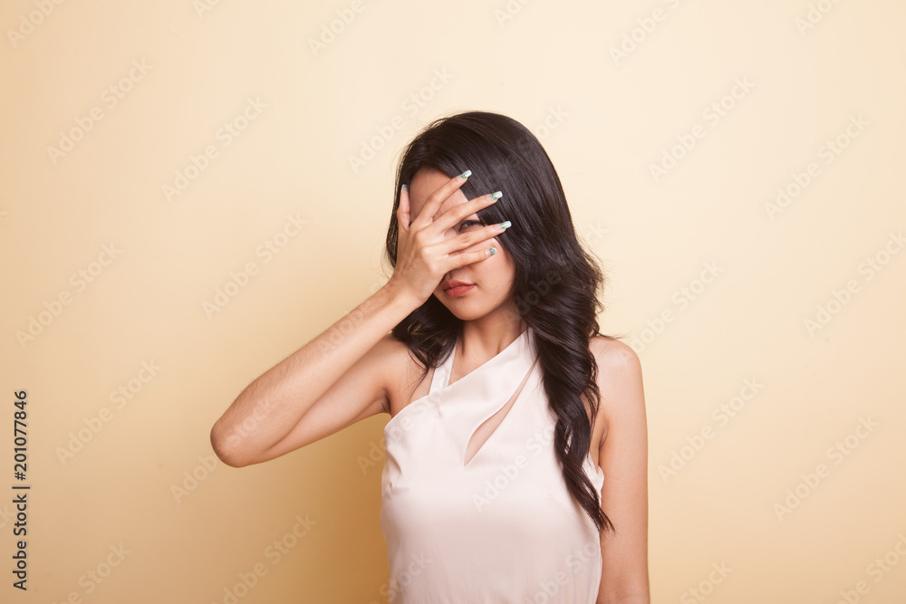Beautiful young Asian woman peeking through fingers. Beautiful young Asian woman peeking through fingers.
