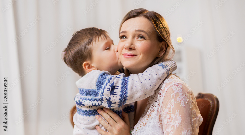 family, expressions and love concept - happy little son kissing his mother