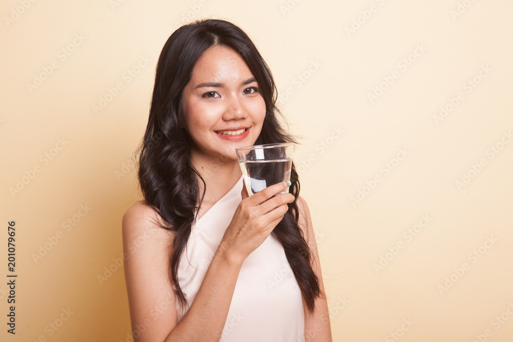 Young Asian woman with a glass of drinking water. Young Asian woman with a glass of drinking water.