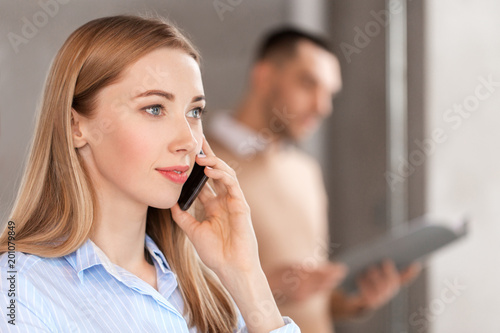 business people  technology and corporate concept - close up of businesswoman calling on smartphone at office