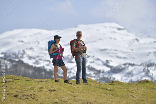 Couple of hikers walking to the mountains