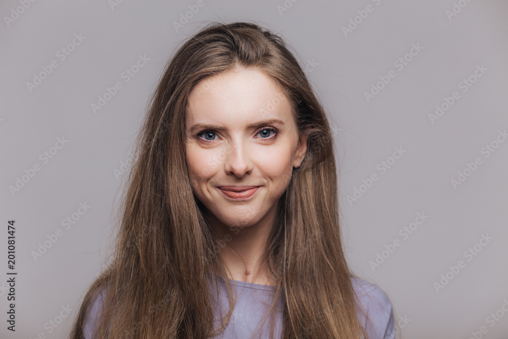 Brunette delighted blue eyed female model with satisfied expression, happy to recieve compliment, isolated over grey background. Lovely dark haired young woman feels content, models in studio Brunette delighted blue eyed female model with satisfied expression, happy to recieve compliment, isolated over grey background. Lovely dark haired young woman feels content, models in studio