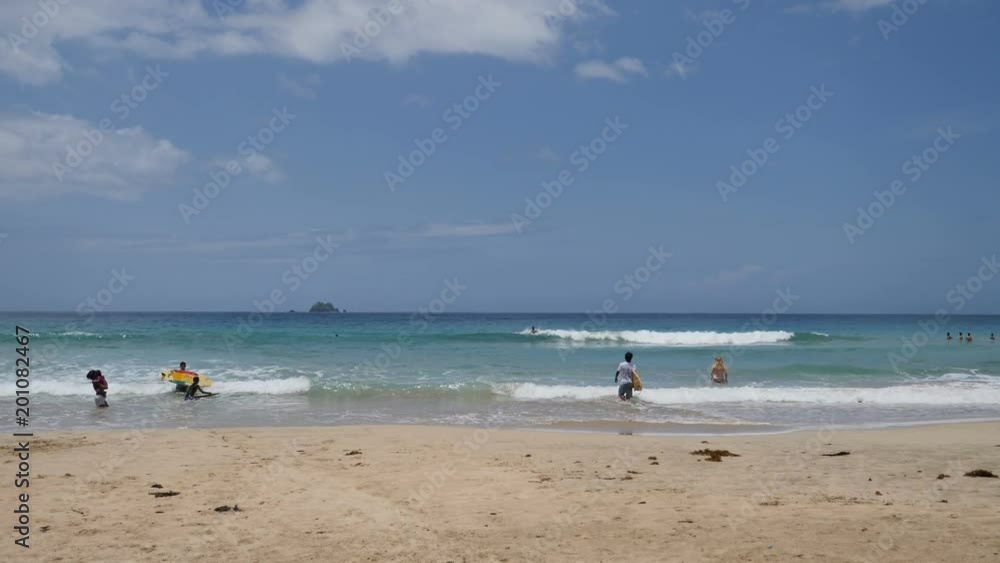People in sea on tropical beach of Nagtabon Beach People in sea on tropical beach of Nagtabon Beach