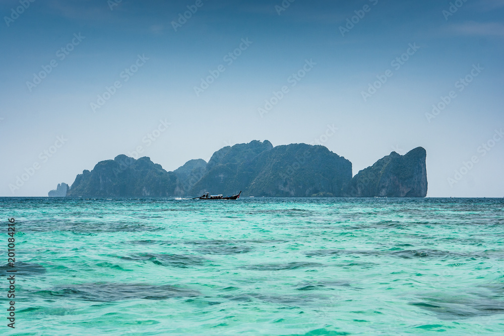 Phi Phi Leh, seen from Tonsai bay, in Koh Phi Phi Island, Thailand. Blue sea water and boats.
