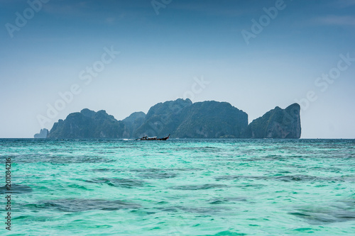 Phi Phi Leh, seen from Tonsai bay, in Koh Phi Phi Island, Thailand. Blue sea water and boats. © Giulio