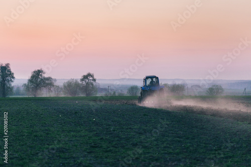 Agricultural machinery in field on the Sunset.
