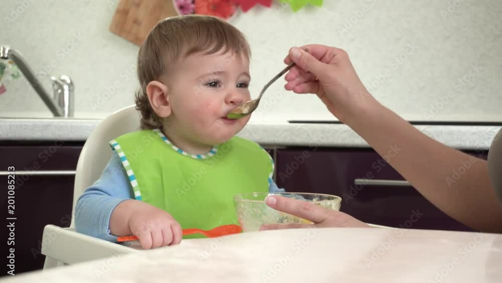 Mom feeds her son Mom feeds her son