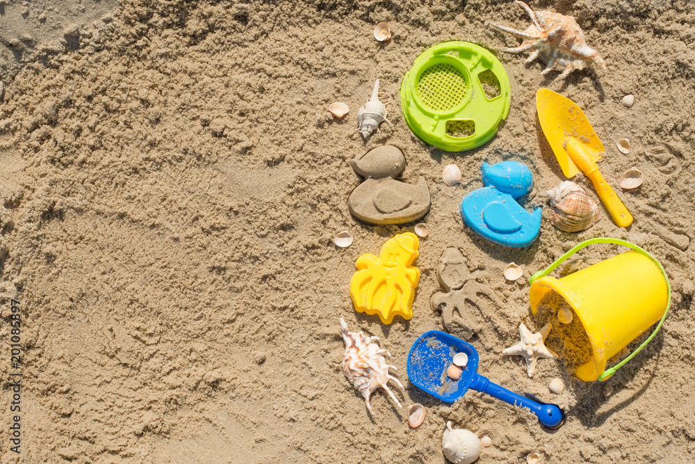 Children's toys on the beach, on the sand with an empty space for writing or advertising Children's toys on the beach, on the sand with an empty space for writing or advertising