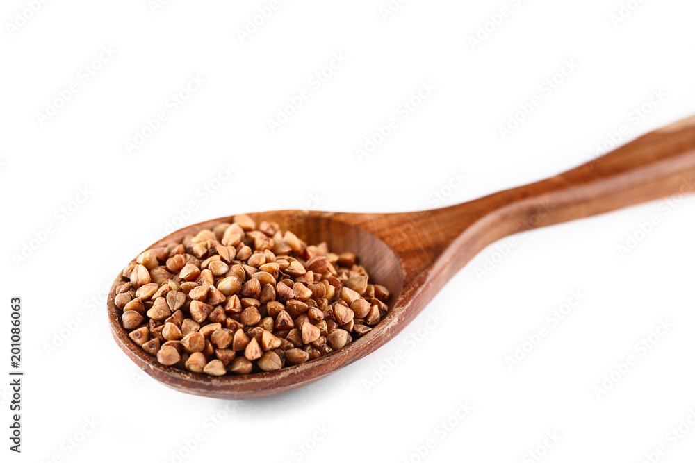 buckwheat in wooden spoon on white background. Isolate. Top view