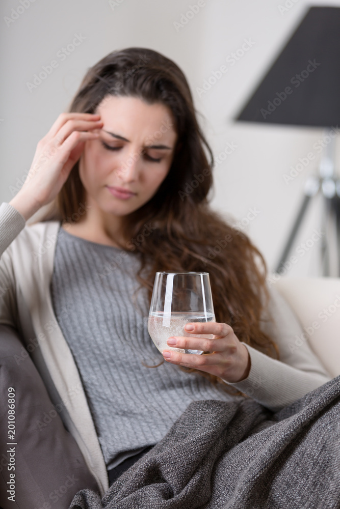 Headaches woman takes pill with glass of water Headaches woman takes pill with glass of water