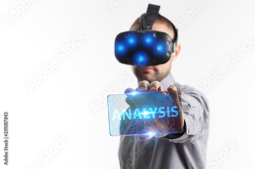 Business, Technology, Internet and network concept. Young businessman working in virtual reality glasses sees the inscription: Analysis