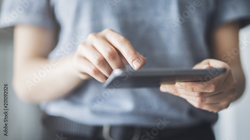 Tapety artystyczne Woman using digital tablet close up view