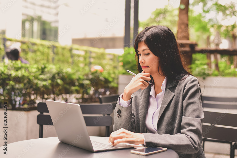 Business Concept.Young Asian businesswoman is working happily.Young businesswoman working in a cafe.Young businesswoman is relaxation in a coffee shop. Business Concept.Young Asian businesswoman is working happily.Young businesswoman working in a cafe.Young businesswoman is relaxation in a coffee shop.