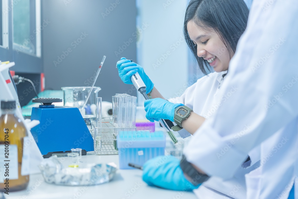 The scientists injected chemicals into plastic tubes,Scientist mix chemicals with The shake machine Before the experiment.Mixture laced with samples into test tubes,prepare sample for test The scientists injected chemicals into plastic tubes,Scientist mix chemicals with The shake machine Before the experiment.Mixture laced with samples into test tubes,prepare sample for test