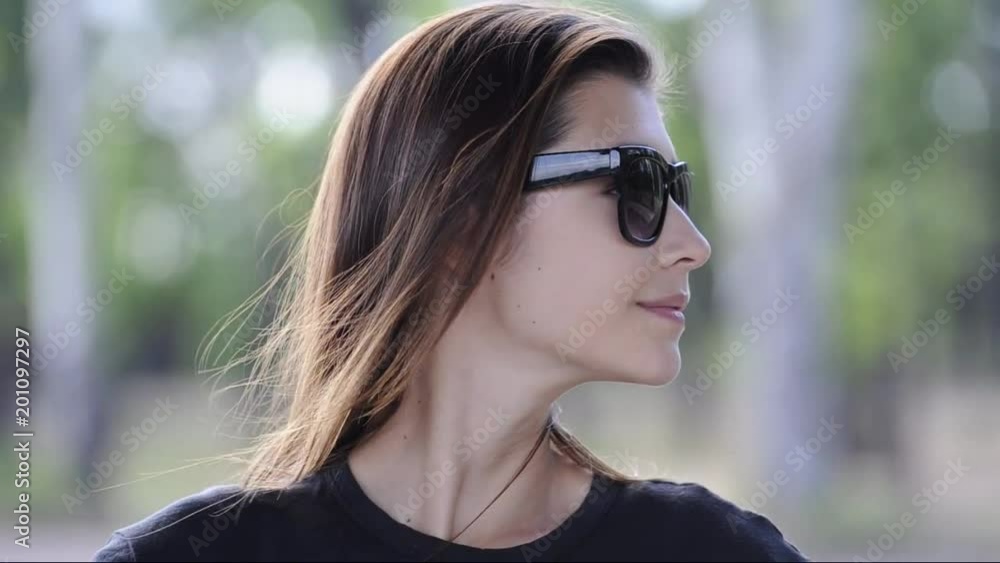 beautiful young woman with long hair in sunglasses looks. on both sides. beautiful young woman with long hair in sunglasses looks. on both sides.