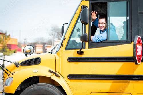 School bus driver waving out window