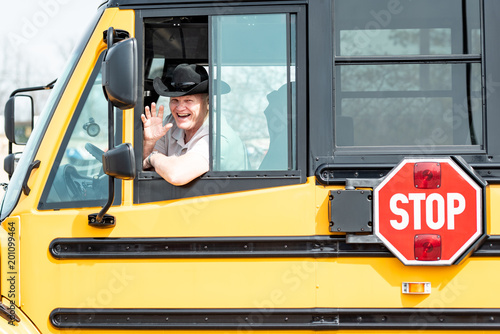 School bus driver waving out window