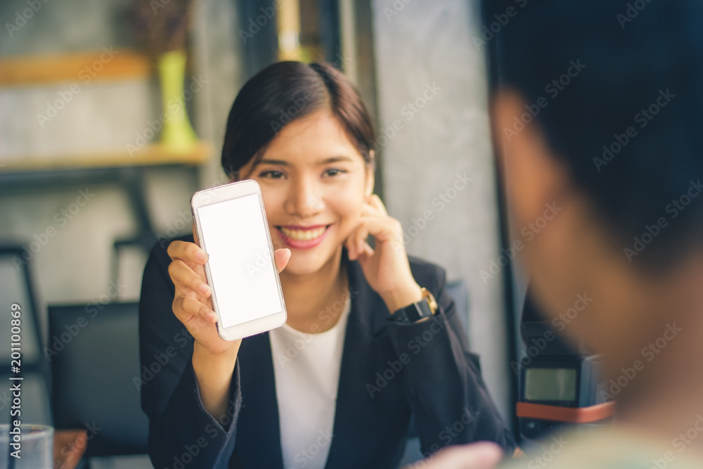 Asian business woman showing smartphone with white screen. Asian business woman showing smartphone with white screen.