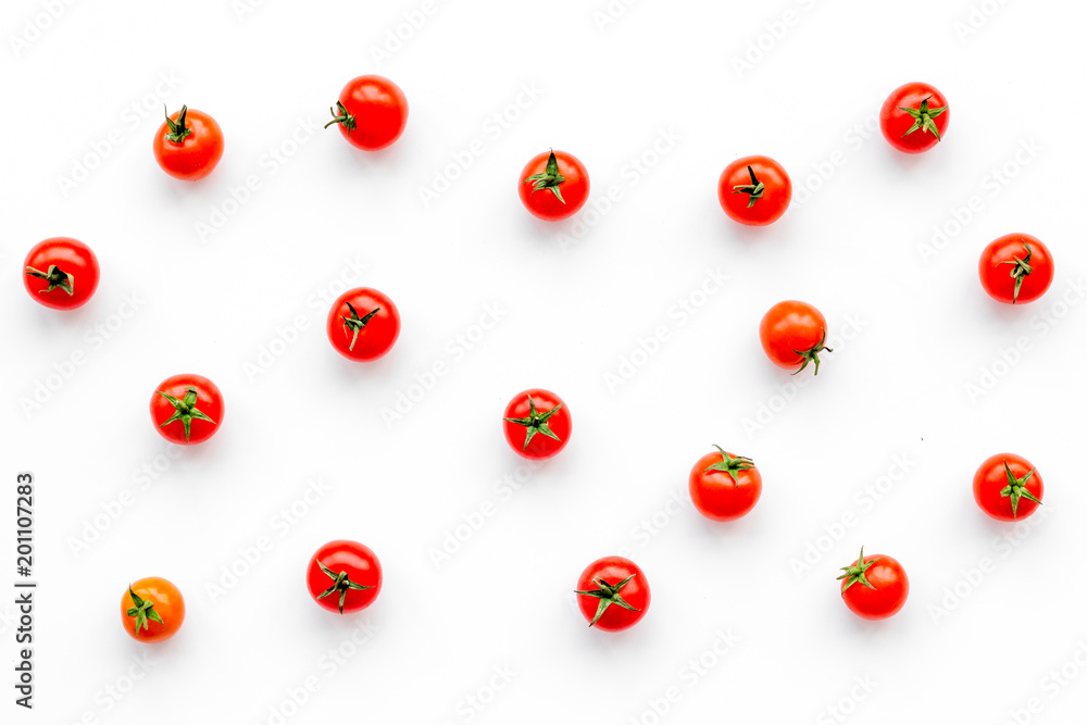 Fresh red cherry tomatoes scattered on white background top view Fresh red cherry tomatoes scattered on white background top view