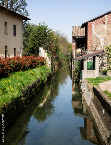 a small stream feeds an old mill. Italy