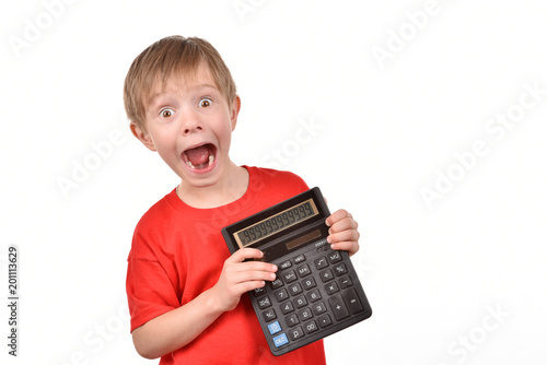Boy with a calculator. A teenager is learning to count.