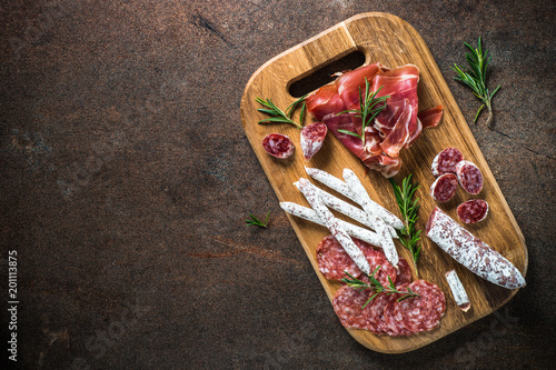 Obraz na plátne Antipasto - sliced meat, ham, salami, olives and wine  top view.