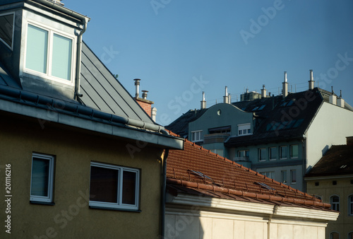 Sunny roof with attic, chimneys and TV antennas