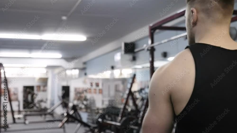 Bodybuilder goes to the gym. Slow motion video