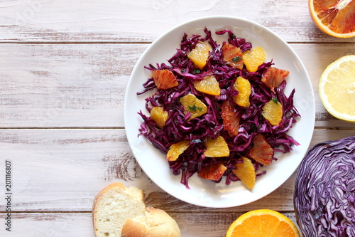 Vegetarian and vegan dish. Red cabbage with orange. Top view.