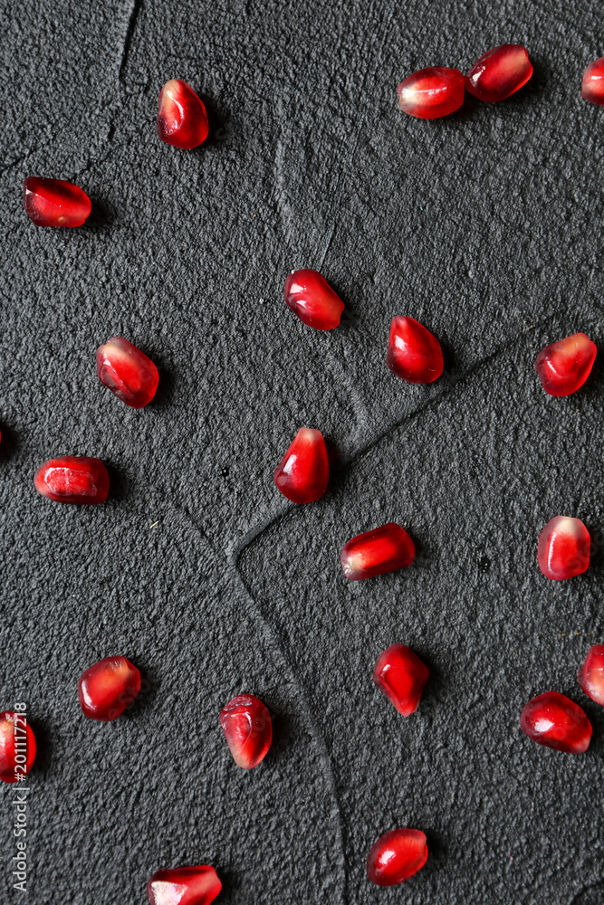 Fresh yummy pomegranate seeds on dark background Fresh yummy pomegranate seeds on dark background