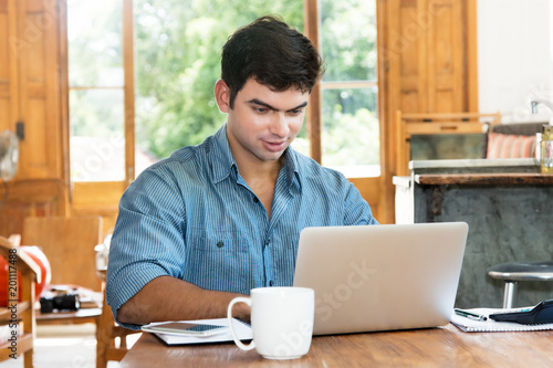 Man working at home at computer photo