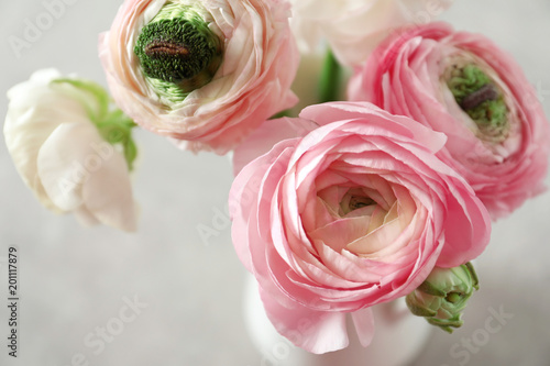 Beautiful ranunculus flowers on light background, closeup