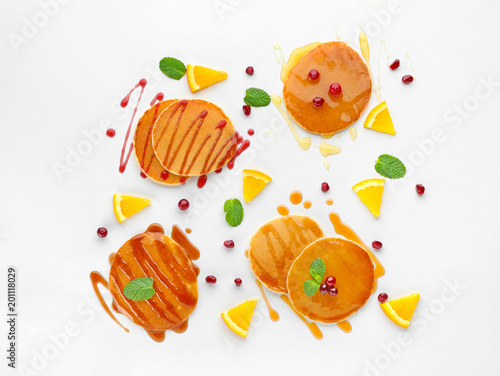 Fototapeta Naklejka Na Ścianę i Meble -  Delicious pancakes with fruits and jam on white background