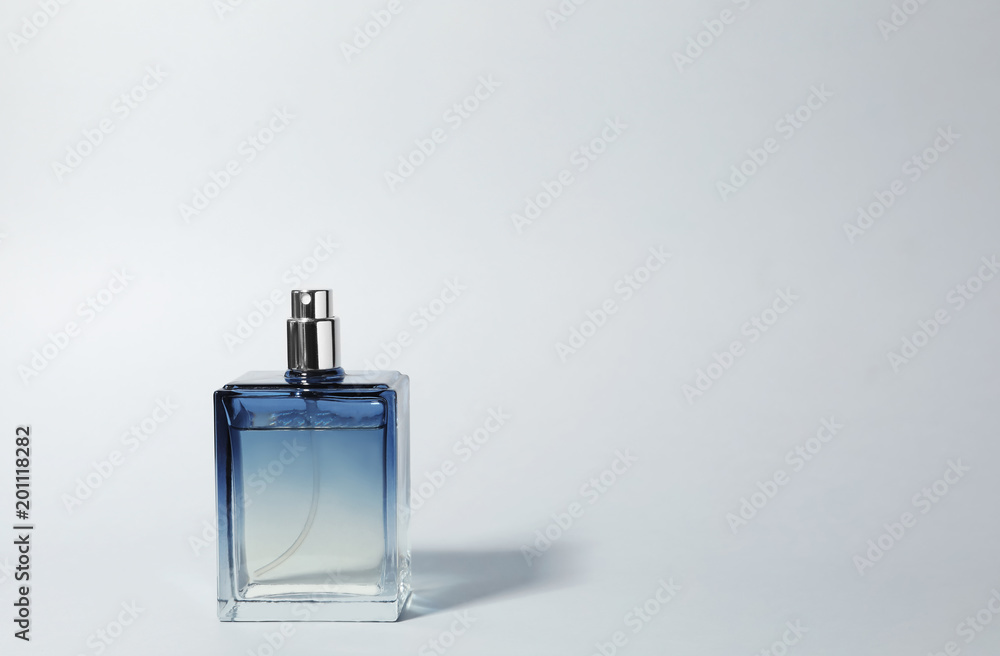 Bottle of perfume on light background - obrazy, fototapety, plakaty 