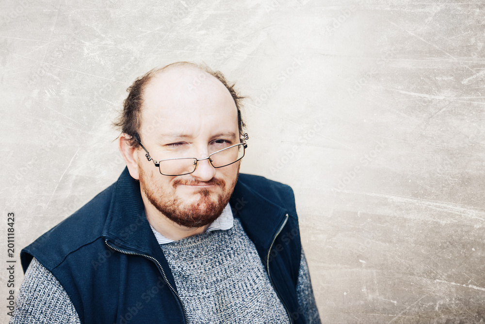 textured, bald man in a sweater and glasses, he frowned. textured, bald man in a sweater and glasses, he frowned.