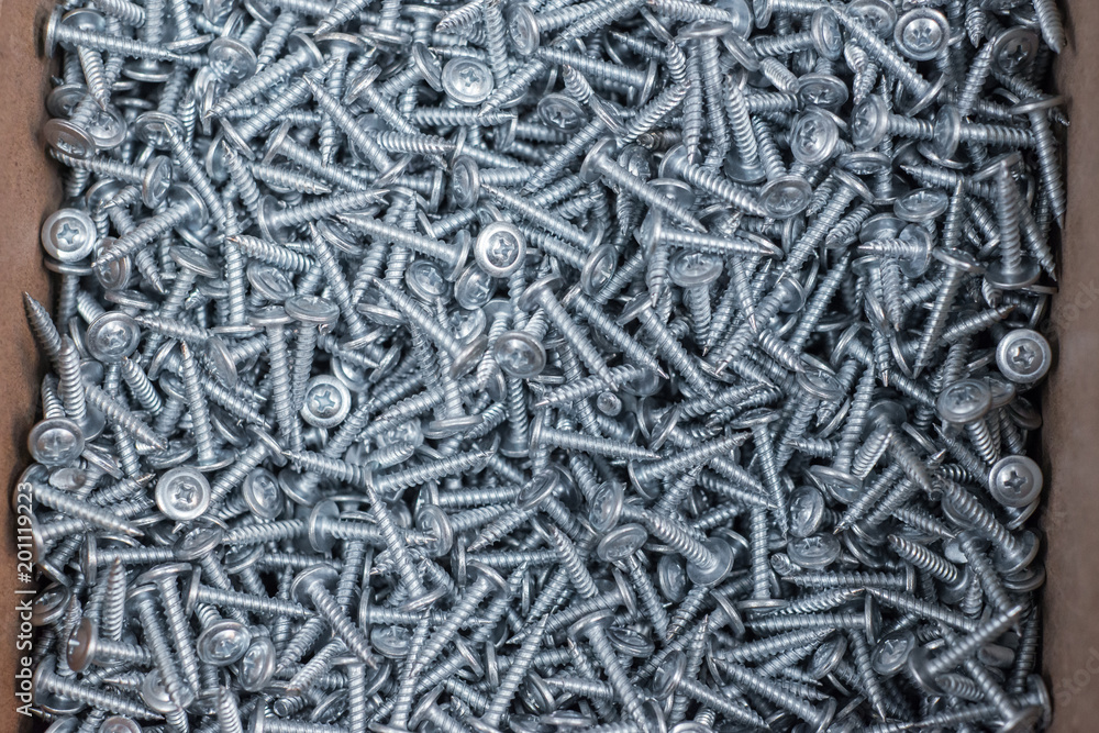 A huge pile of new metal screws.
A huge pile of new metal screws.