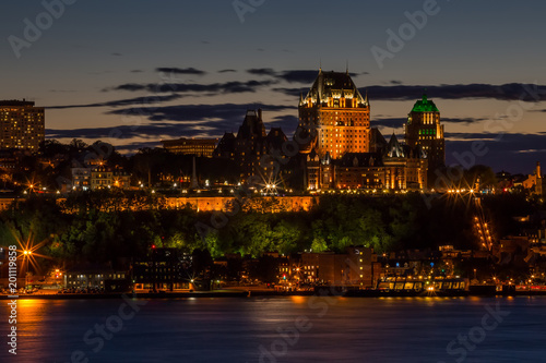 City skyline of Quebec, Canada. Illuminated buildings against the evening sky.