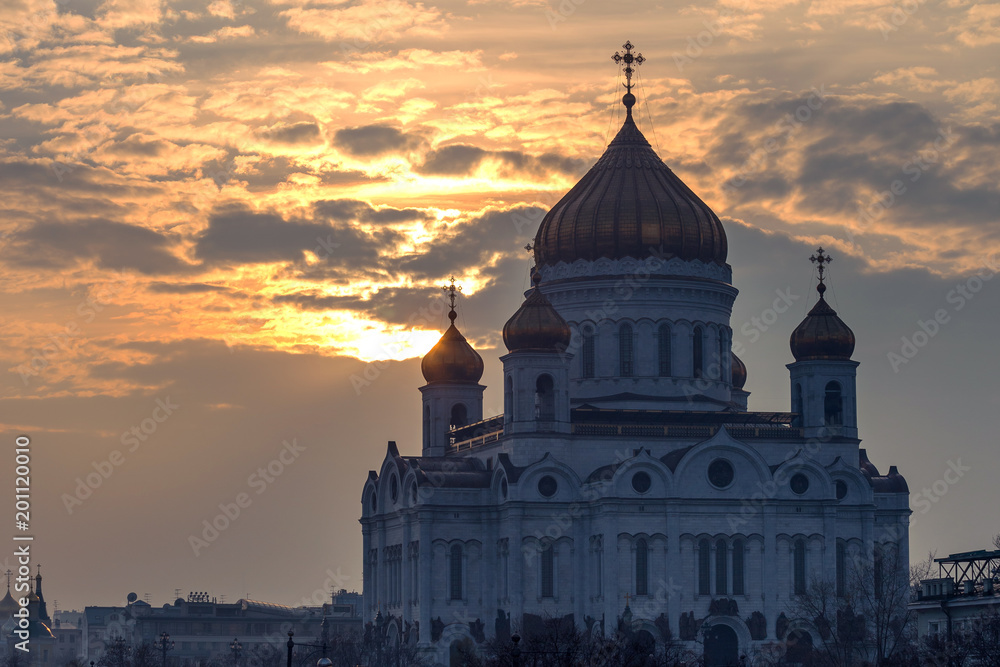 Orthodox Cathedral of Christ the Savior against the dramatic sky at sunset, Moscow, Russia.