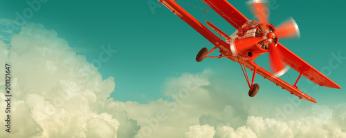 Photo Red biplane flying in the cloudy sky. Retro style