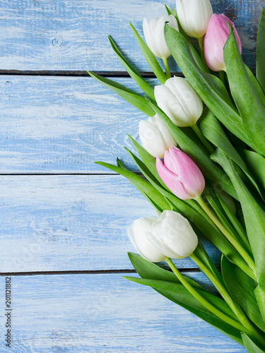 white tulips on wooden surface