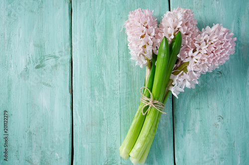 Fresh pink flowers hyacinths on woden surface