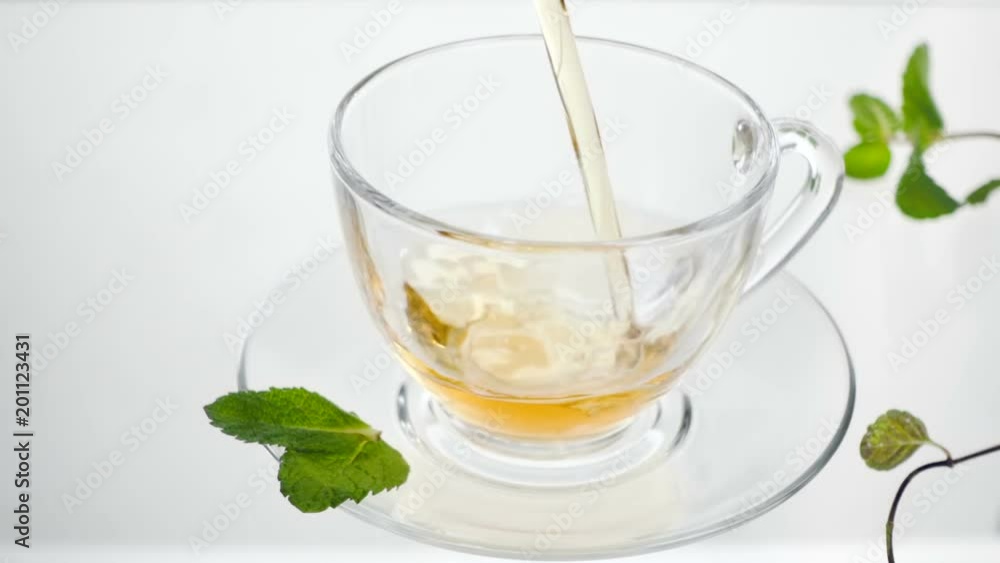 Hot herbal tea with ginger, lemon and mint. Ginger beverage in transparent teapot. Healthy lemon tea. Hot herbal tea with ginger, lemon and mint. Ginger beverage in transparent teapot. Healthy lemon tea.