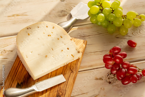 Dutch hard cheese Maasdam or Emmentaler, cheese with holes and white hard goat cheese with coriander