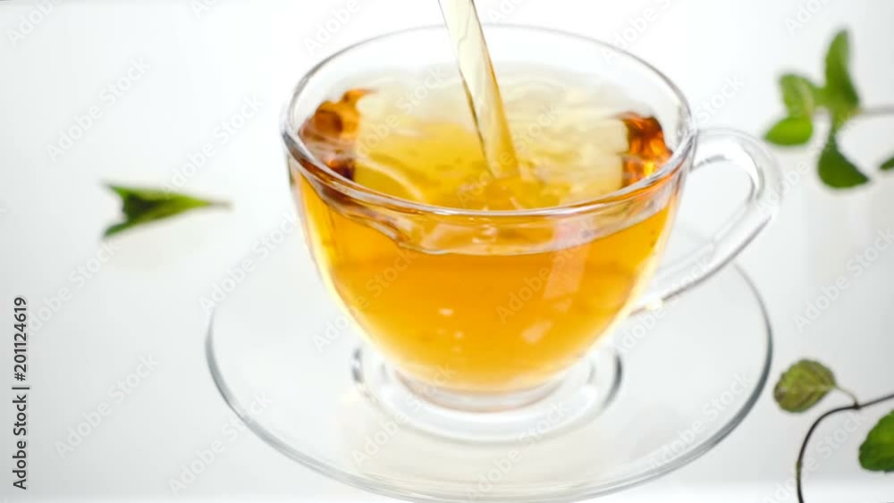 Hot herbal tea with ginger, lemon and mint. Ginger beverage in transparent teapot. Healthy lemon tea. Hot herbal tea with ginger, lemon and mint. Ginger beverage in transparent teapot. Healthy lemon tea.