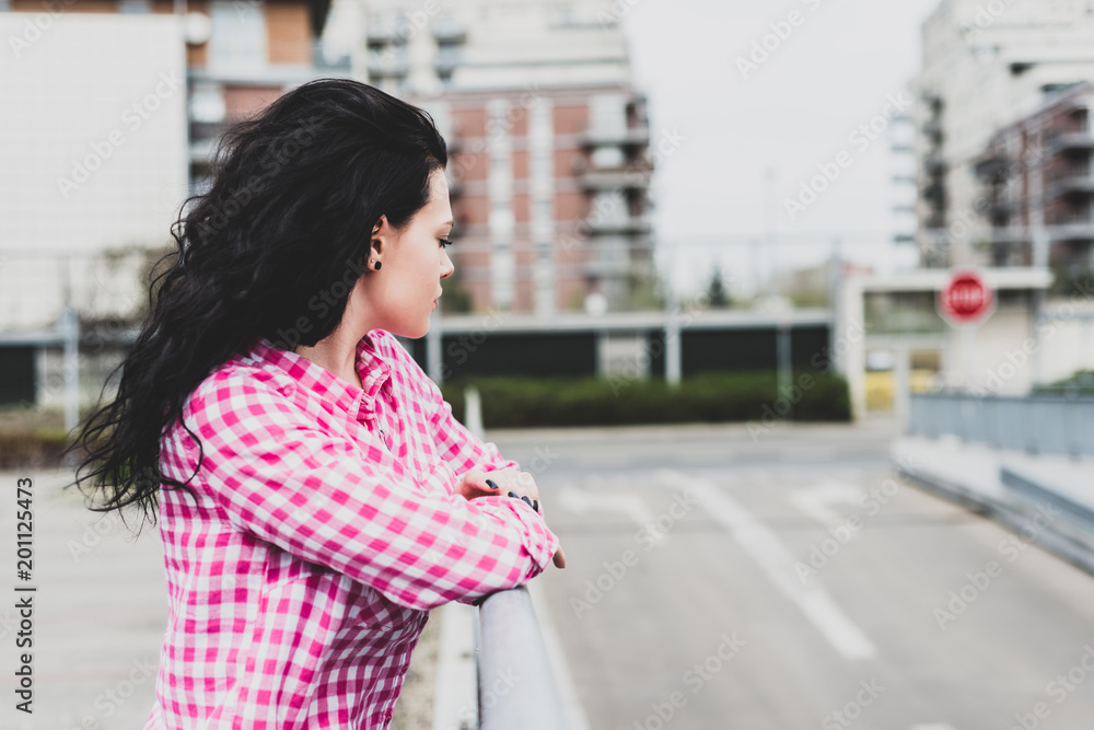 Close up portrait of a pretty girl looking at street. A young and lovely woman thoughtful. Concept lifestyle.
